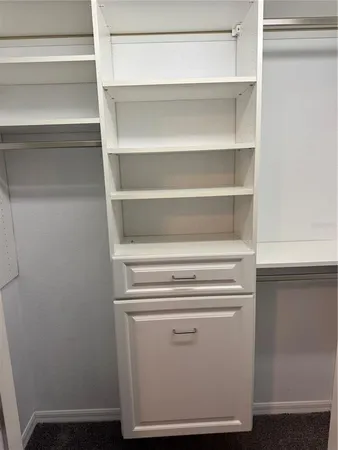 a view of walk in closet with empty racks