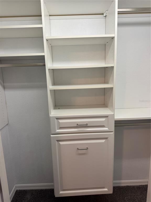 6315 Rosefinch Court, Unit 101 Lakewood Ranch, FL 34202 - Photo 21 of 30 a view of walk in closet with empty racks