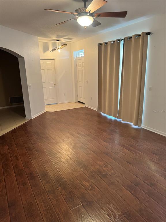 6315 Rosefinch Court, Unit 101 Lakewood Ranch, FL 34202 - Photo 24 of 30 an empty room with wooden floor and a ceiling fan