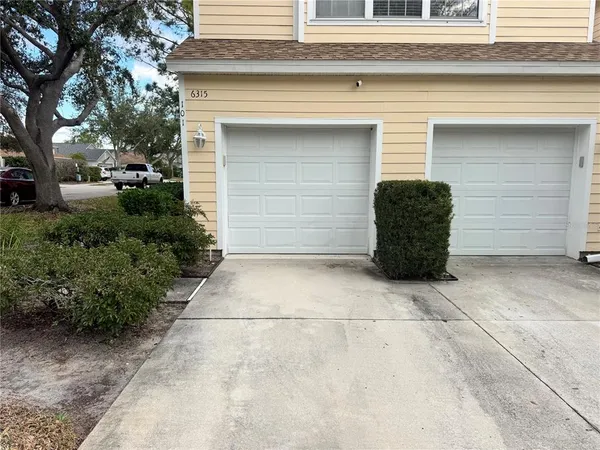 a couple of potted plants in front of door