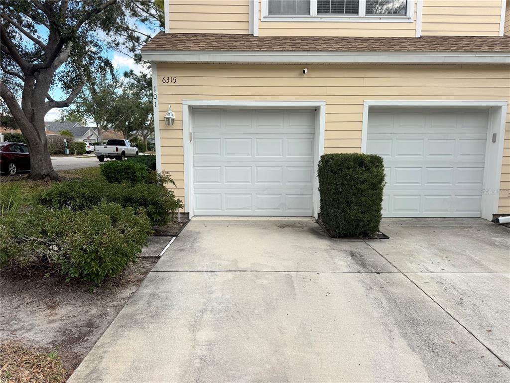 6315 Rosefinch Court, Unit 101 Lakewood Ranch, FL 34202 - Photo 3 of 30 a couple of potted plants in front of door