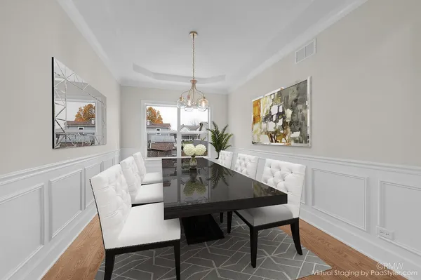 a view of a dining room with furniture a chandelier and wooden floor