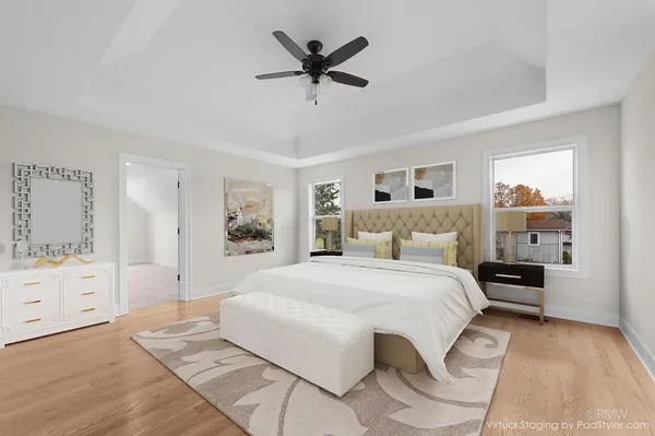 a bedroom with a large bed and a chandelier