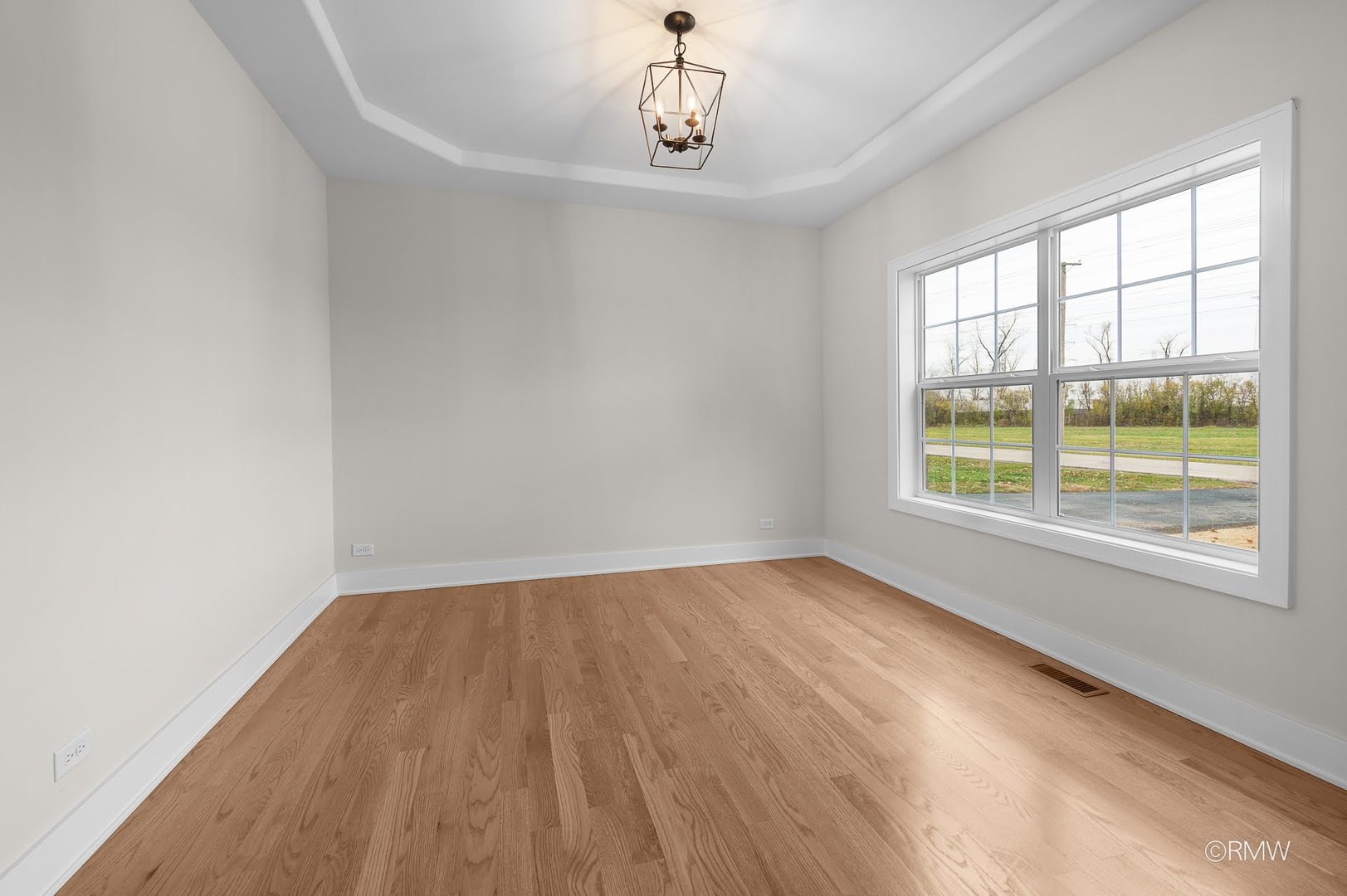 25-w275 Doris Avenue Carol Stream, IL 60188 - Photo 7 of 34 a view of an empty room with wooden floor and a window