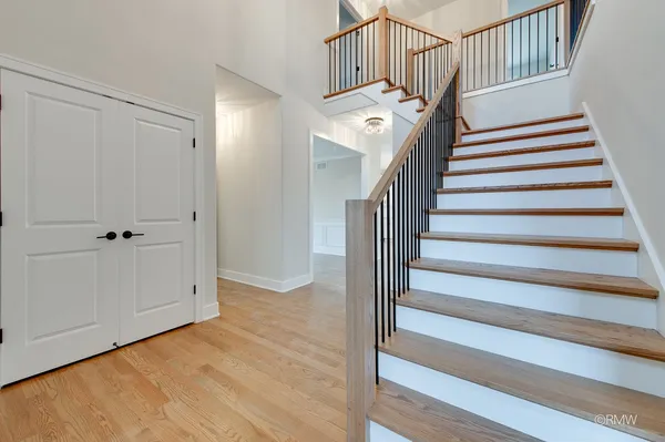 a view of entryway and hall with wooden floor