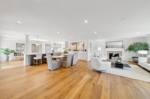 a living room with fireplace furniture and a wooden floor