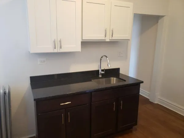 a kitchen with cabinets counter top space and a sink