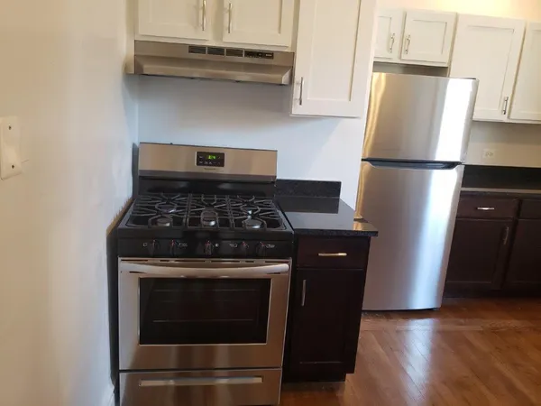 a kitchen with stainless steel appliances granite countertop a stove a refrigerator and a refrigerator