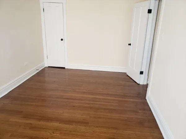 a view of a room with wooden floor