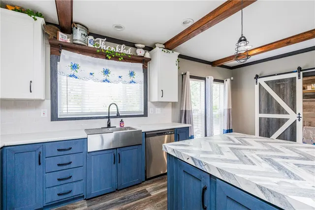 a kitchen with a sink cabinets and window