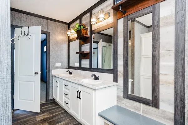 a bathroom with a double vanity sink and mirror