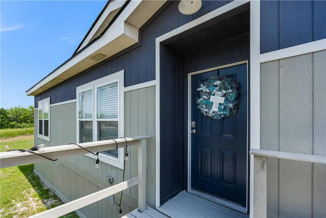 a view of a balcony with furniture and front door