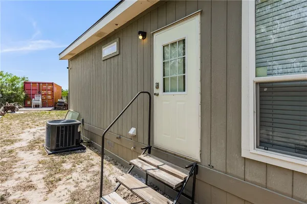 a backyard of a house with barbeque oven