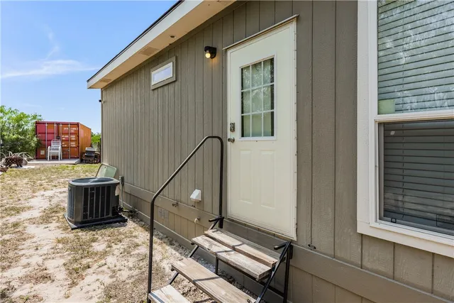a backyard of a house with barbeque oven