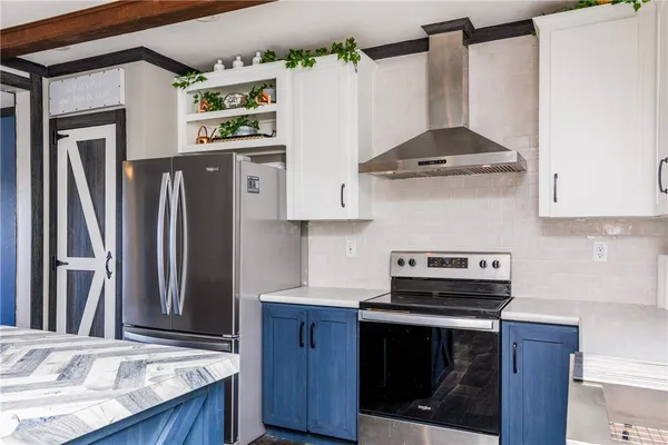 a kitchen with stainless steel appliances granite countertop a stove a refrigerator and a wooden cabinets