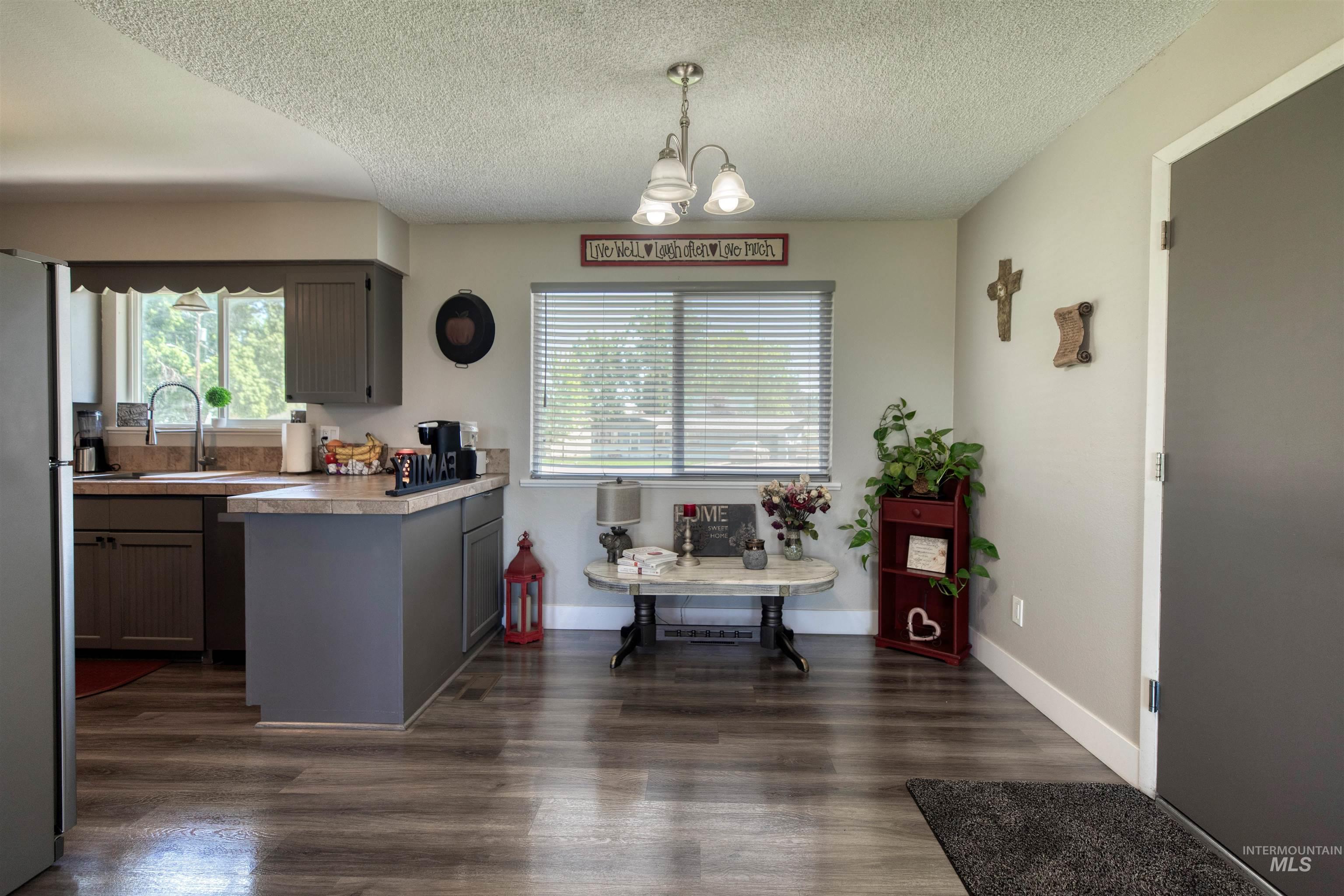20803 Friends Road Greenleaf, ID 83626 - Photo 36 of 39 Kitchen and dining area featuring wood-finish flooring