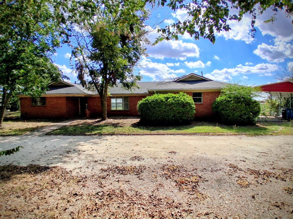 Single story home with brick siding and a shingled roof