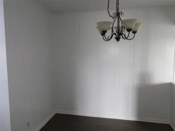a view of small space with wooden floor and windows