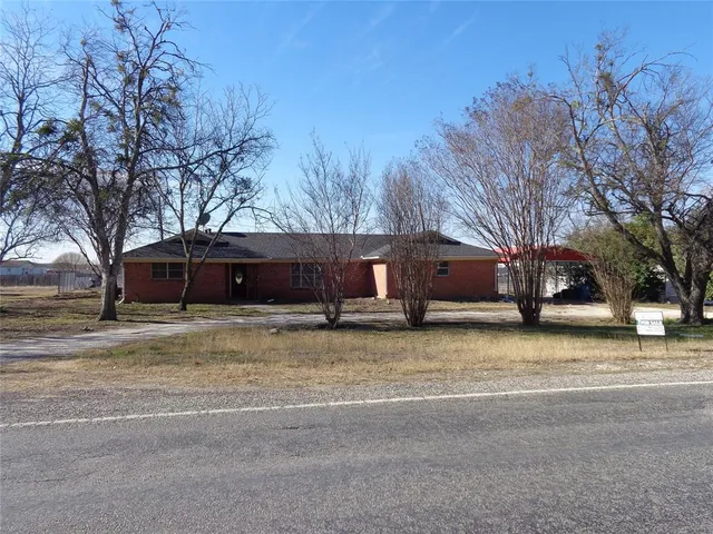 a house that has a tree in front of it