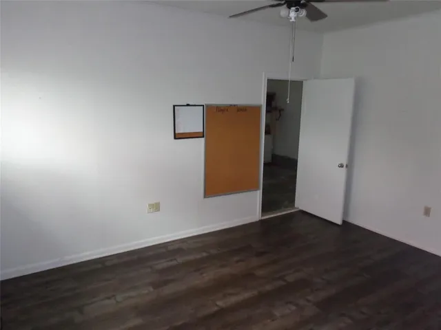 an empty room with wooden floor and closet
