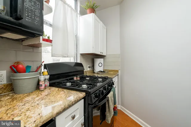 a kitchen with stainless steel appliances granite countertop a stove and a sink