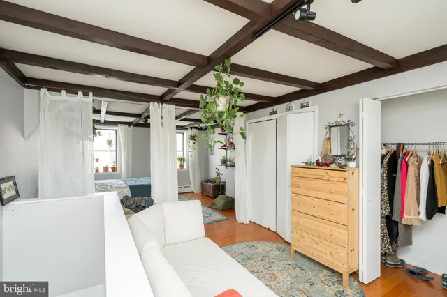 a bedroom with a bed next to a window