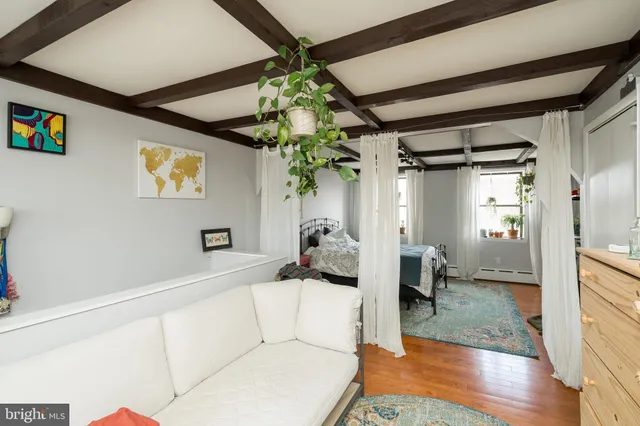 a bedroom with furniture and a window