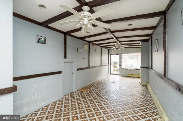 a bathroom with a sink a toilet a window and a shower