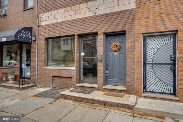 a living room with furniture and potted plants