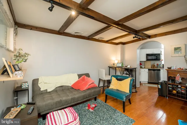 a living room with furniture and a book shelf