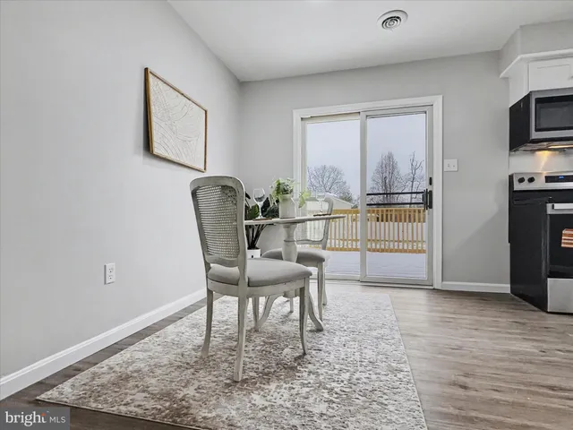 a dining room with furniture and a window