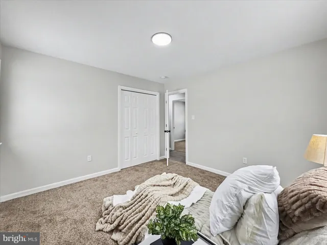 a bedroom with bed and a window