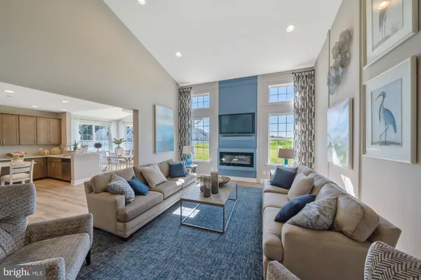 a living room with furniture fireplace and a large window