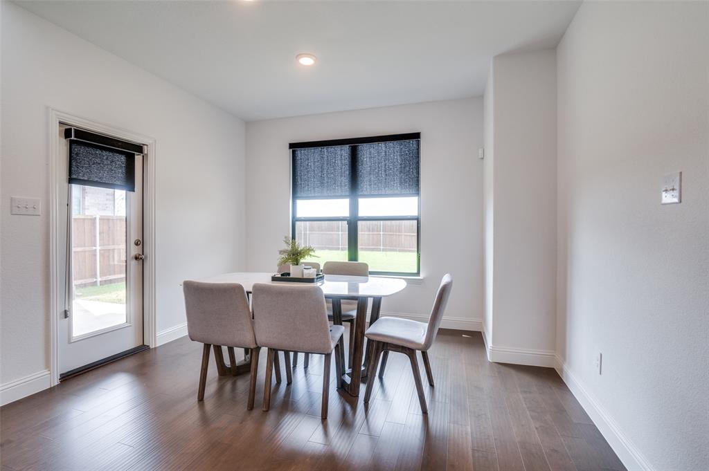 1749 Wassel Road Fort Worth, TX 76052 - Photo 10 of 25 a view of a dining room with furniture and wooden floor