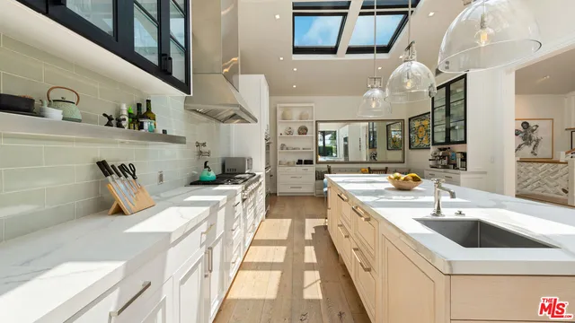 a view of a kitchen with cabinets and wooden floor