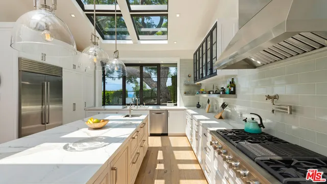 a kitchen with stove and cabinets