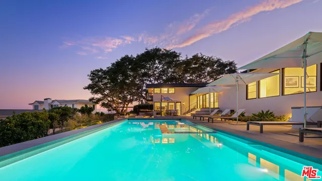 a swimming pool view with a yard