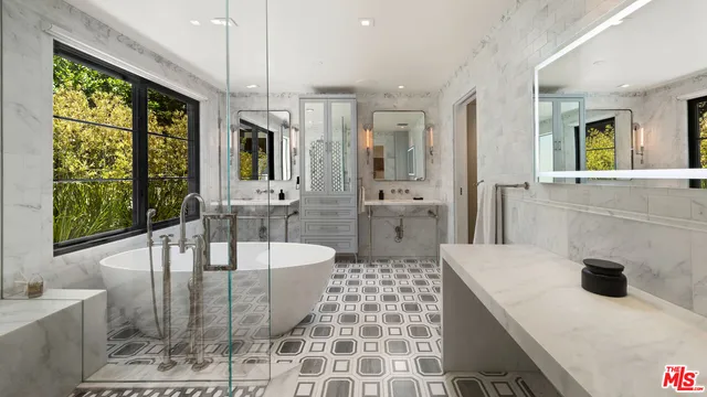 a living room with lots of furniture and a floor to ceiling window