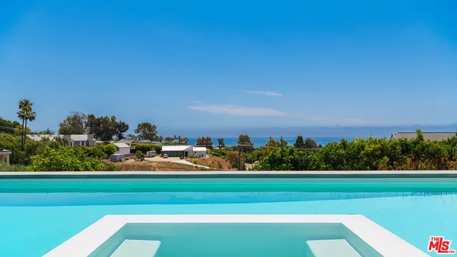 a view of house with swimming pool outdoor seating
