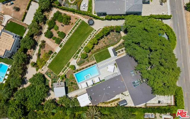 a front view of a house with a tree