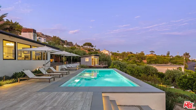 a view of a swimming pool with a patio