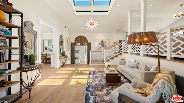 a living room with furniture a rug and a chandelier