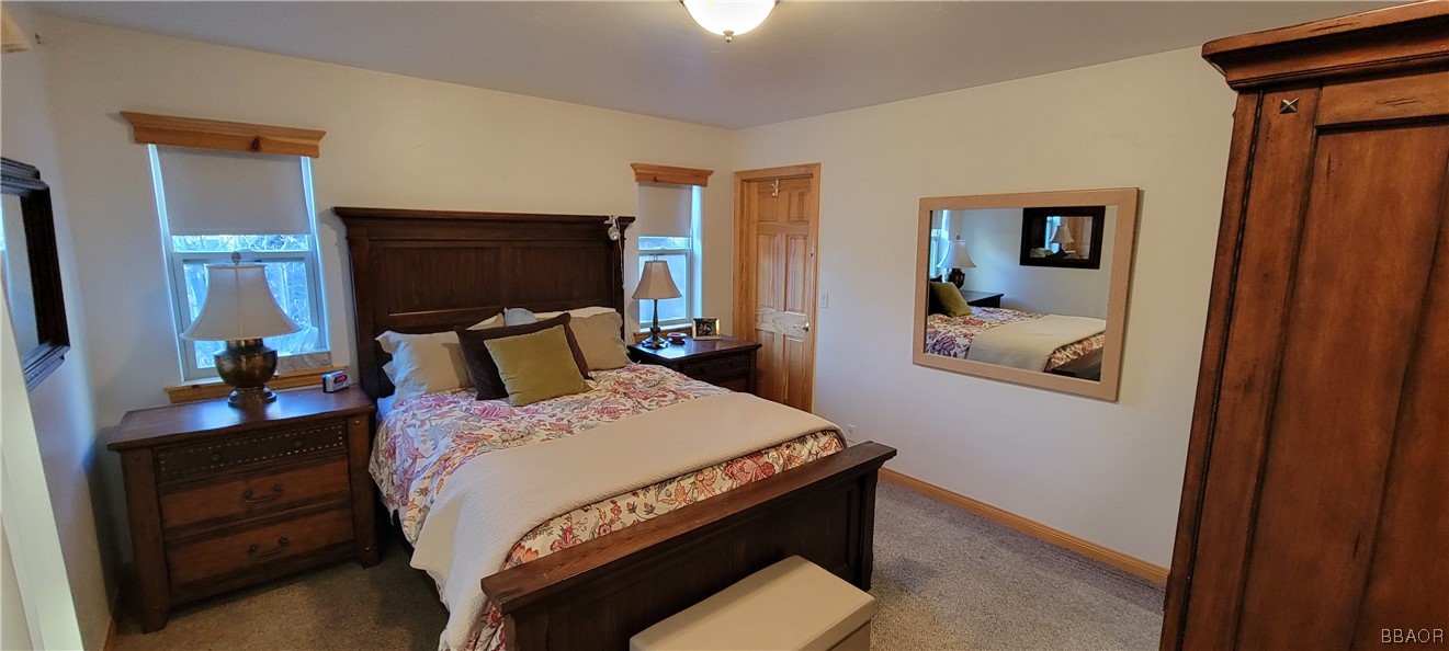1685 Angels Camp Road Big Bear City, CA 92314 - Photo 11 of 35 a bedroom with a bed and wooden floor