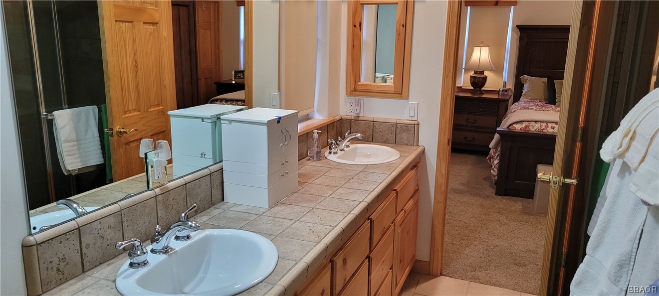 1685 Angels Camp Road Big Bear City, CA 92314 - Photo 13 of 35 a bathroom with a double vanity sink and a mirror