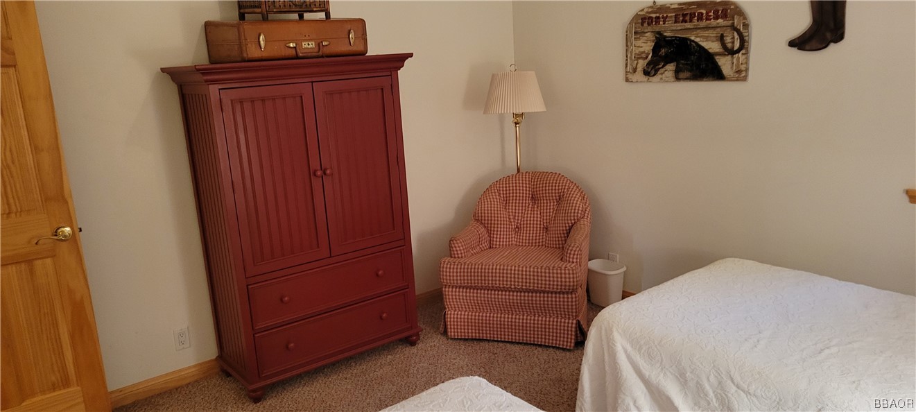 1685 Angels Camp Road Big Bear City, CA 92314 - Photo 24 of 35 a bedroom with a bed and cabinets