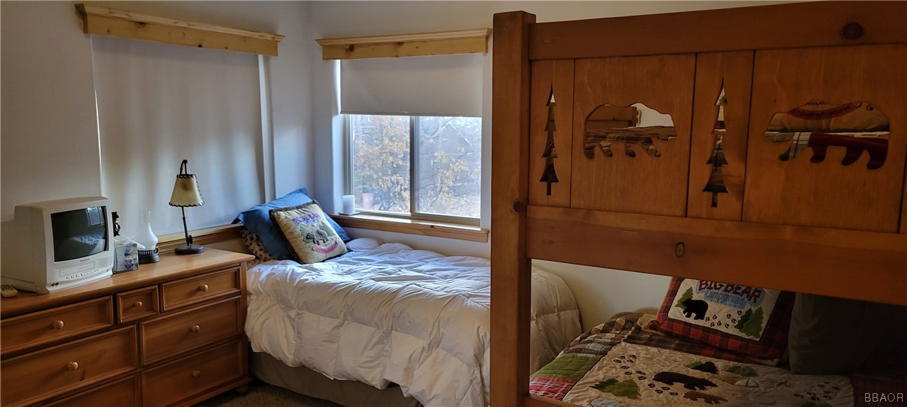 1685 Angels Camp Road Big Bear City, CA 92314 - Photo 26 of 35 a bed room with a bed and a mirror