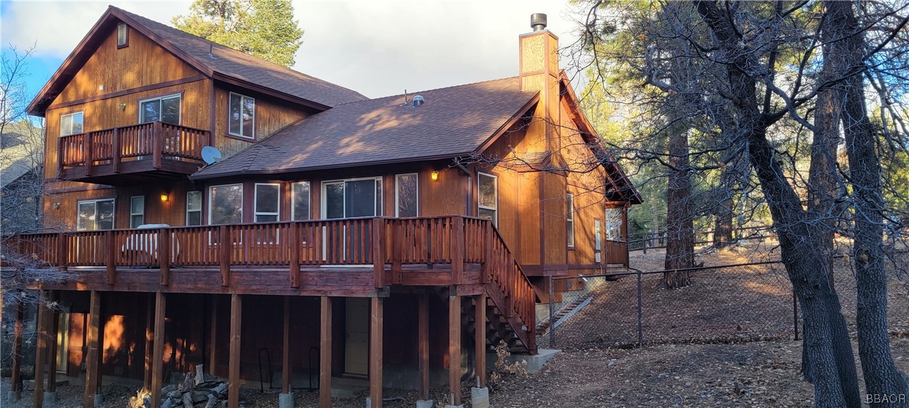 1685 Angels Camp Road Big Bear City, CA 92314 - Photo 35 of 35 a view of a house with wooden fence and a tree