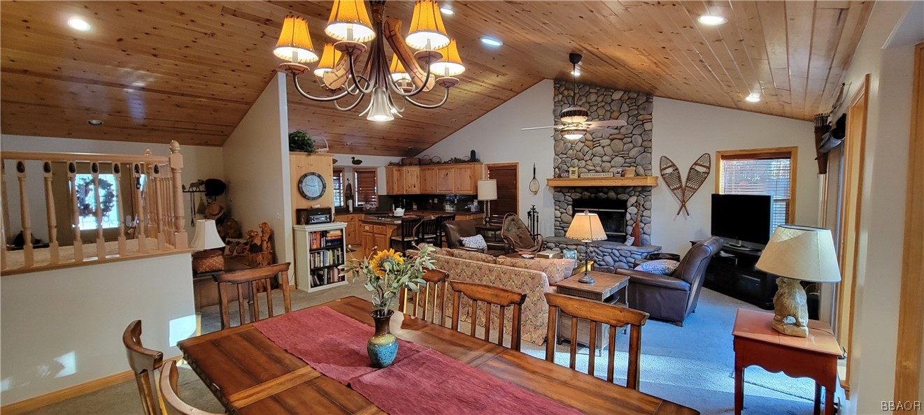 1685 Angels Camp Road Big Bear City, CA 92314 - Photo 4 of 35 a view of a dining room with furniture a chandelier and wooden floor