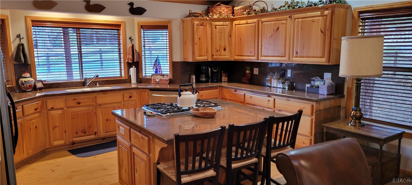 1685 Angels Camp Road Big Bear City, CA 92314 - Photo 8 of 35 a kitchen with stainless steel appliances granite countertop a stove a sink and a microwave