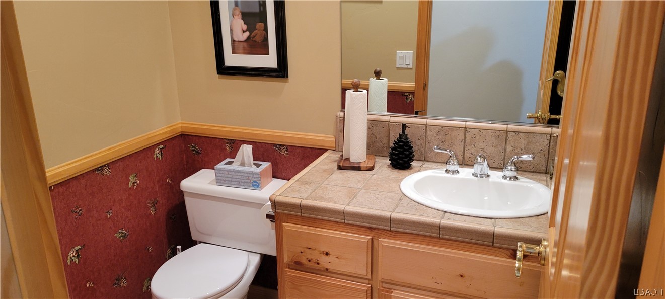 1685 Angels Camp Road Big Bear City, CA 92314 - Photo 10 of 35 a bathroom with a toilet sink and mirror